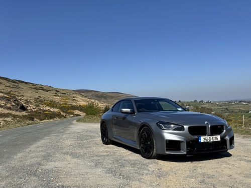 Grey BMW M2 sports car parked on a rural road