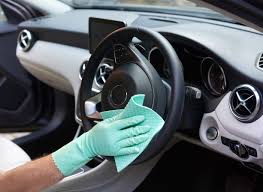 Lady-cleaning-interior-car-steering-wheel