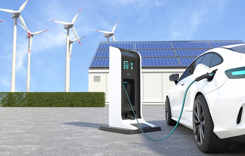 White electric car charging at EV station