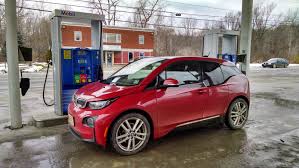 BMW i3 3 2017 version red side view at charger station